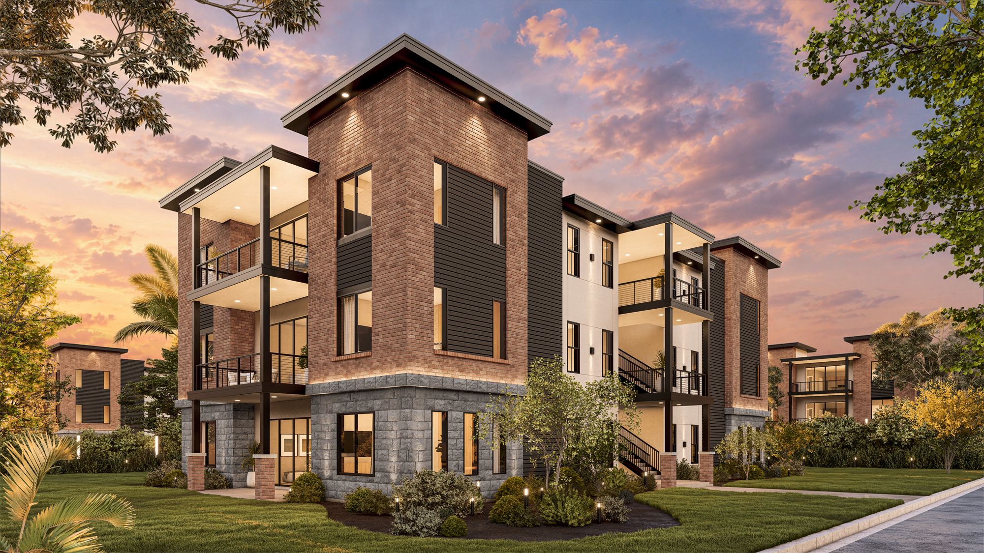 Corner perspective of the Carmel apartment building showing brick, stone, and dark siding