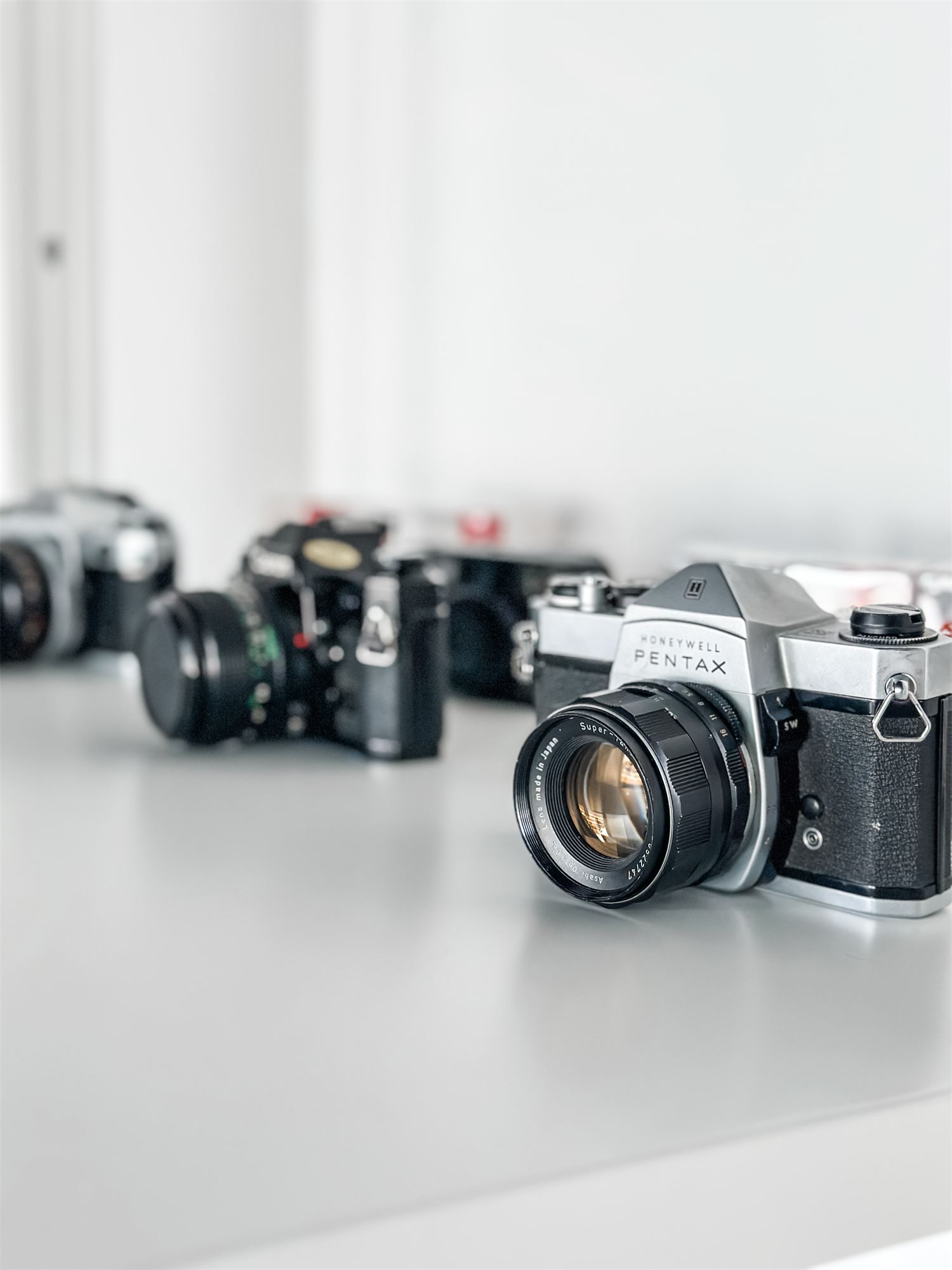 Film cameras displayed on a white counter at Not Another Film Lab