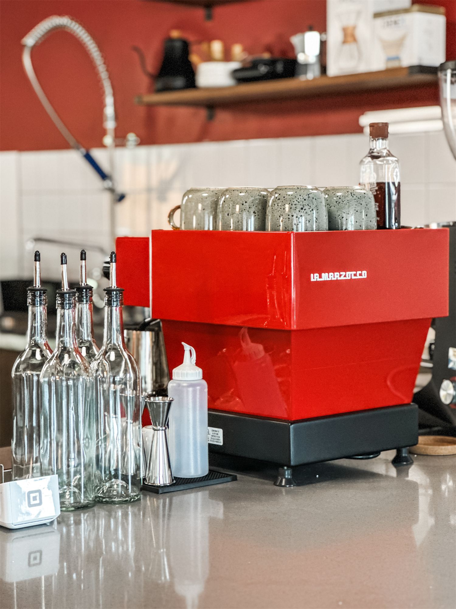 Red espresso machine on the counter at Not Another Film Lab