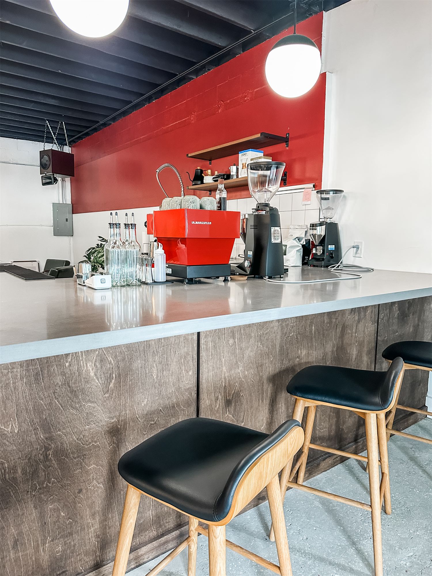 Bar stools along the service counter at Not Another Film Lab