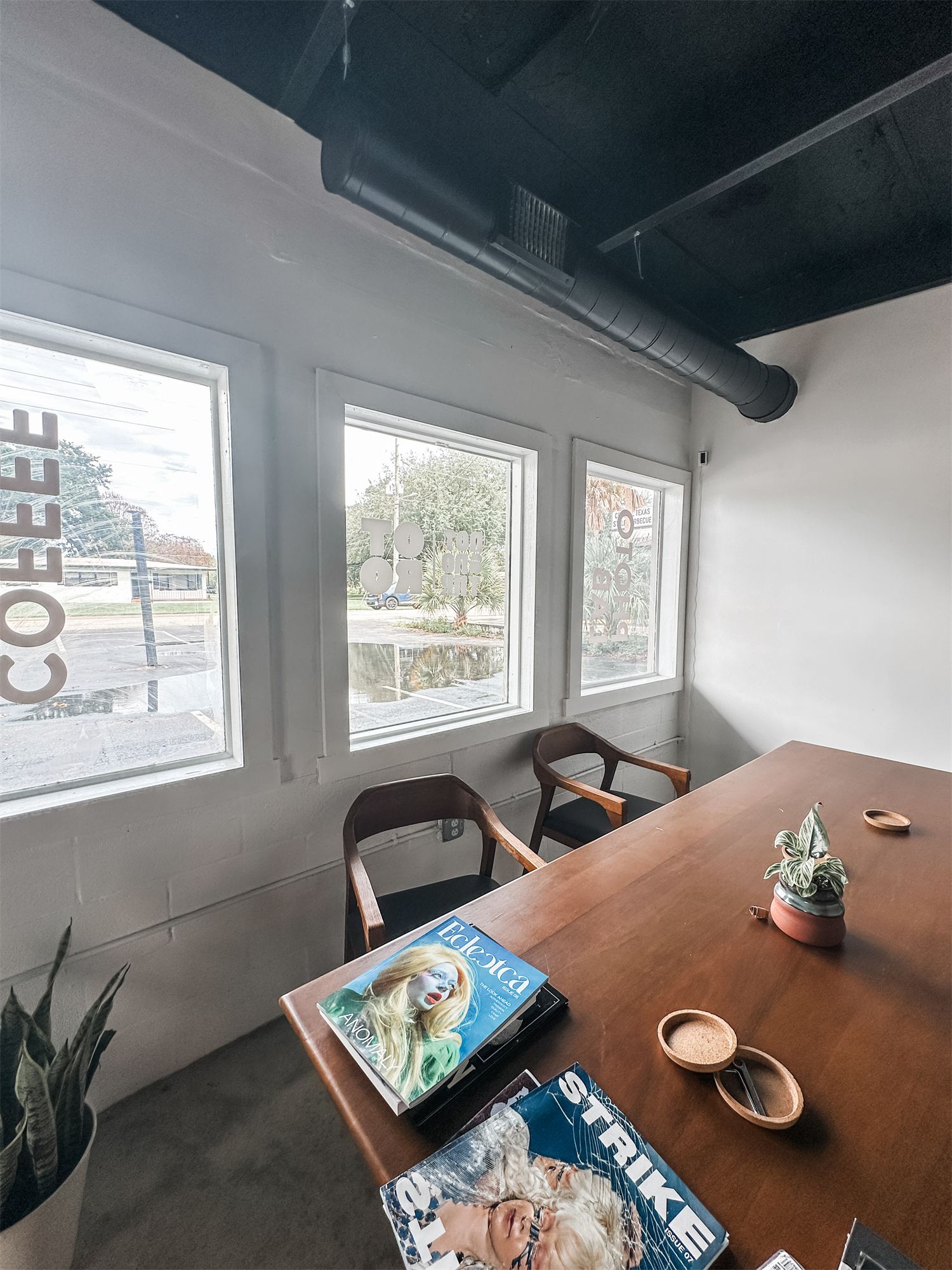 Seating nook by the front windows at Not Another Film Lab