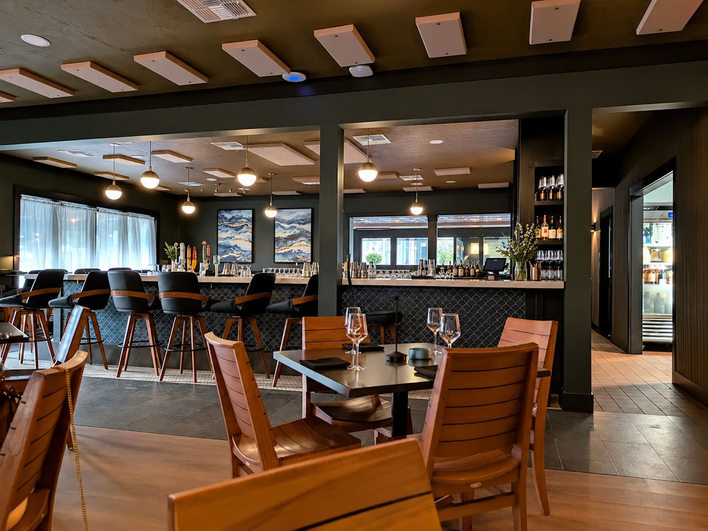 Salt & Ember restaurant dining room and bar in Mount Dora with wood seating and pendant lights